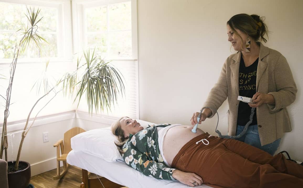 Midwife Laura Doyle listens to Leslie Booher’s baby’s heartbeat using a fetal doppler during an exam at Moonstone Midwives Birth Center on Monday, May 4, 2026 in Eureka, California.